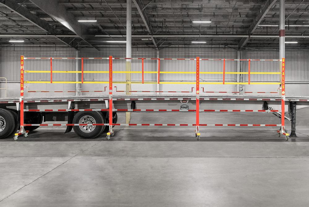 A Truck Fall Prevention Side Rolling Panel System on a flatbed trailer similar to what Steel Dynamics uses